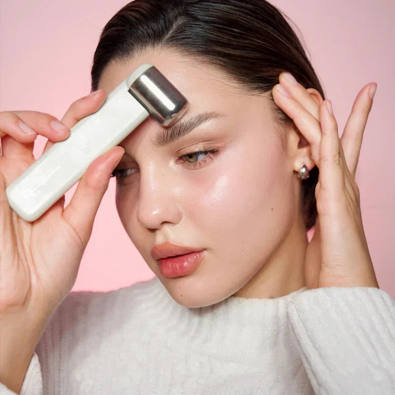 Woman using the Rajani MD CryoGLO Roller on her face as part of a morning skincare routine.