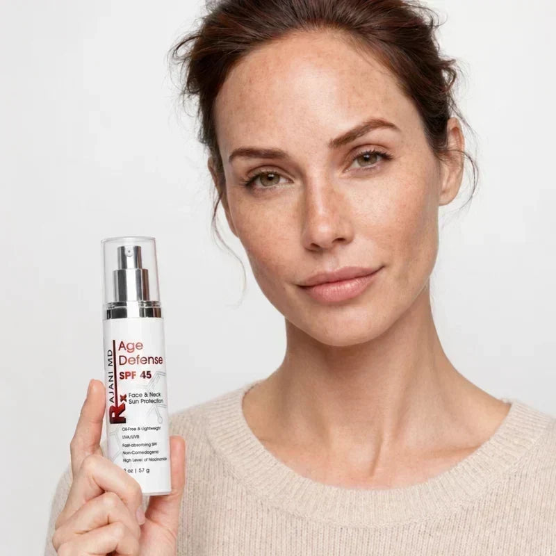 Woman holding Rajani MD Age Defense SPF 45 sunscreen.