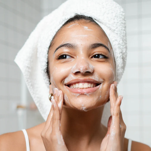 Woman cleansing face with gentle cleanser to remove makeup and support skin barrier.