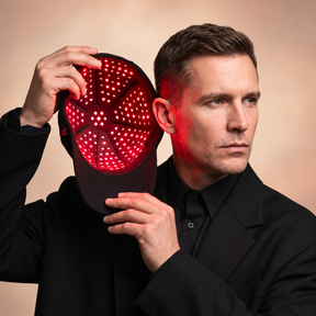 plus-cap-man-showing-light-panel.png	Man holding the Rajani MD PlasmaGLO™ Hair+ Cap open to show the red LED and laser light panel.