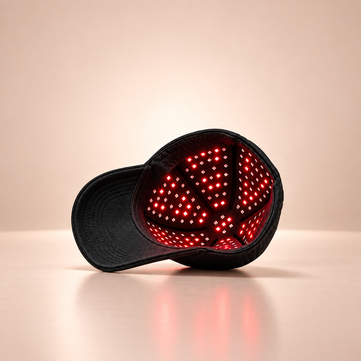Side view of the PlasmaGLO™ Hair+ Cap showing its red light panel, which combines 680 nm laser light with red LEDs.
